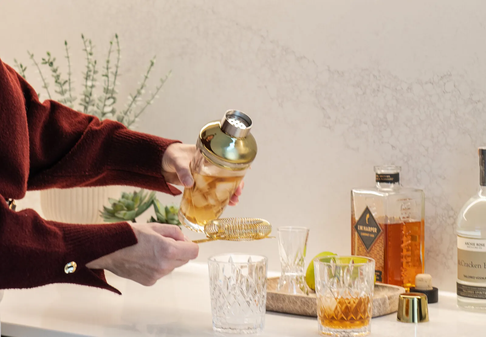 Drinks poured at a stone bench in an Adelaide custom home set for entertaining