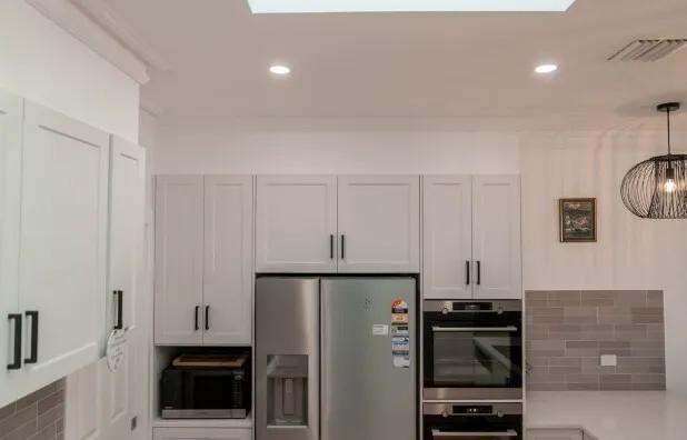 Dornford custom home — white kitchen with skylights